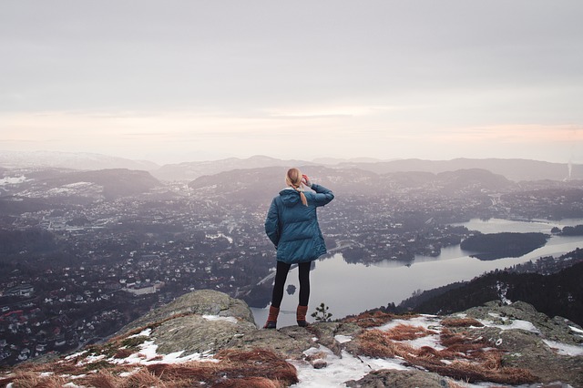 Woman looking at view from top of a mountain